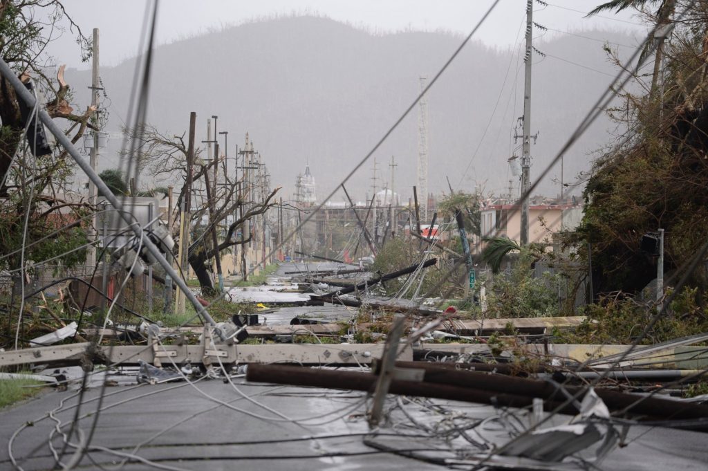 Photo: AP / ABC News Electricity poles and lines lie toppled on the road after Hurricane Maria hit the eastern region of the island, in Humacao, Puerto Rico.